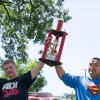 Pizza eating champs Kirk Taylor and Fred Olivas hoist the first-place trophy.